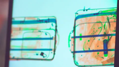 Various personal items scanned in the x-ray airport security checkpoint Stock Footage