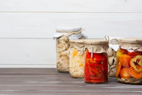 Various pickled fermented vegetables and mushrooms Suillaceae in glass jars o Stock-Fotos