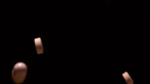 Various pills fall on a black background in slow motion 1000 fps 動画素材 252406229