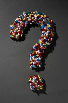 Various pills forming question mark on black background Stock Illustration