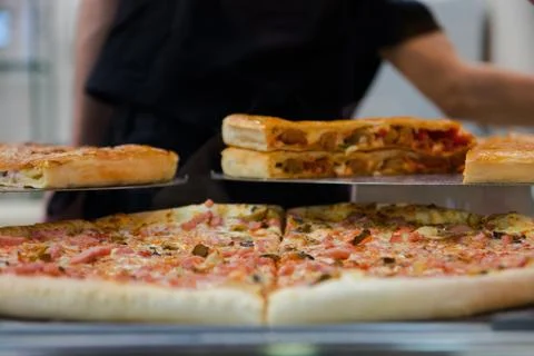 Various pizza on a show-window in cafe with various ingredients Stock Photos