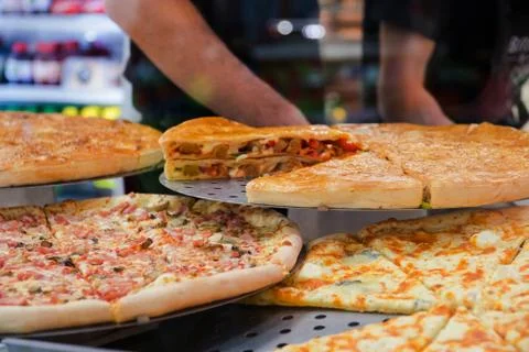 Various pizza on a show-window in cafe with various ingredients Stock Photos