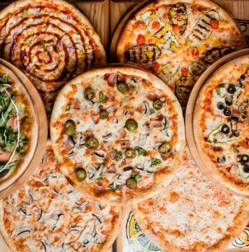 Various pizzas on the table top view Stock Photos