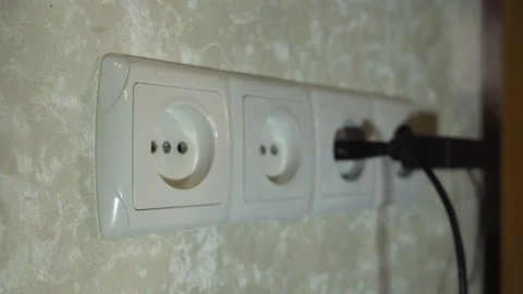 Various plugs of electrical appliances are alternately pulled out of sockets Stock Footage 258766460