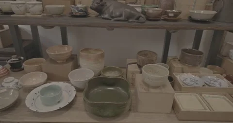 Various pottery items displayed in a rustic setting. Stockbeeldmateriaal 315045896