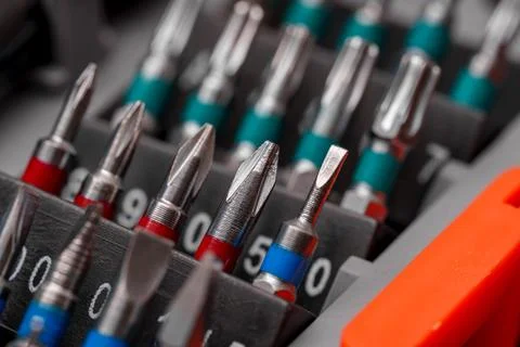 Various precision screwdriver bits arranged neatly in a tool organizer for .. Stock Photos