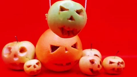 Various pumpkin-like creations made from fruit for Halloween Video stock 344454693