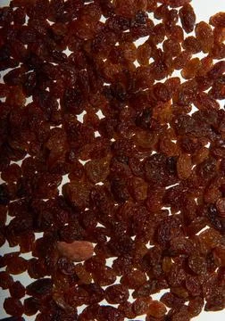 Various raisins spread out on a table Stock Photos