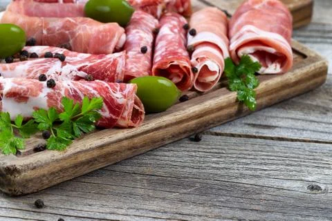 Various raw meats on serving board with rustic background Stock Photos