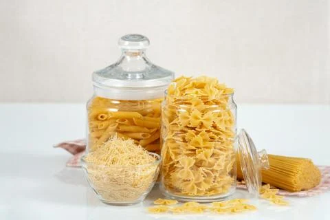 Various raw pasta types on white background Stock Photos
