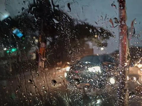 Various reflections, on a rainy and cold night, seen from inside a car. Stock Photos