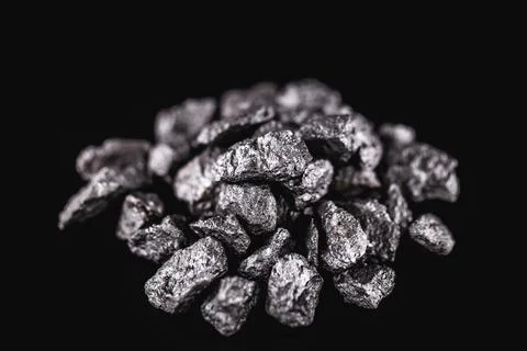Various rough silver nuggets on black background, texture of silvery stones. Stock Photos