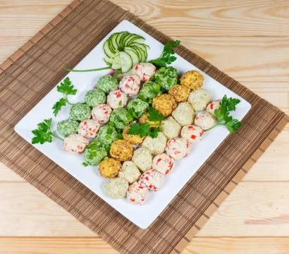 Various salads in the form of balls on square dish Stock Photos