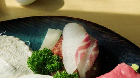Various sashimi are carefully served on a plate. Stock Footage 149857104