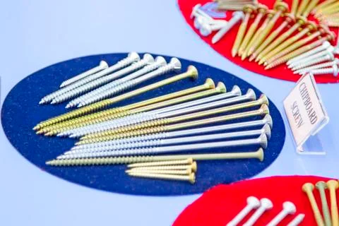 Various screws on Colored backgrounds Stock Photos
