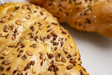 Various seeds on fresh bread texture, soft focus close up Stock Photos
