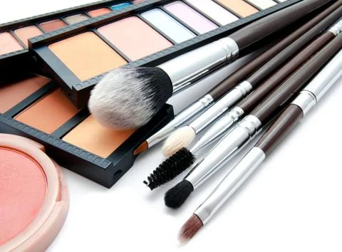 Various set of professional makeup brushes and palette of colourful eye shado Stock Photos