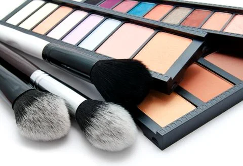 Various set of professional makeup brushes and palette of colourful eye shado Stock Photos