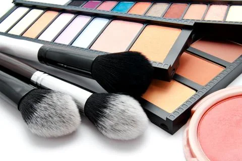 Various set of professional makeup brushes and palette of colourful eye shado Stock Photos