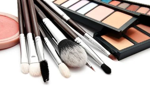 Various set of professional makeup brushes and palette of colourful eye shado Stock Photos
