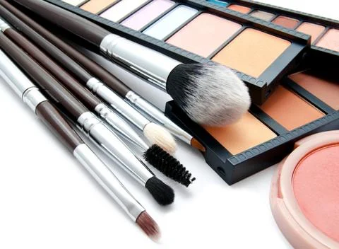 Various set of professional makeup brushes and palette of colourful eye shado Stock Photos