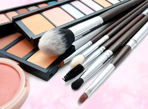 Various set of professional makeup brushes and palette of colourful eye shado Stock Photos
