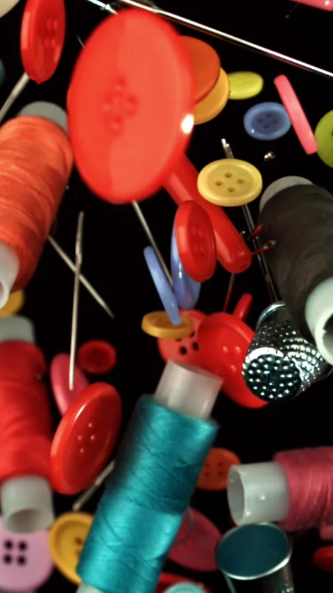 Various sewing accessories fly on a black background. Filmed on a high-speed Stock Footage 335380210