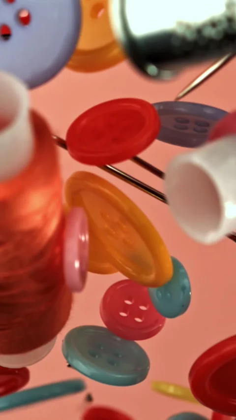 Various sewing supplies fly on a colored background. Filmed on a high-speed Stock Footage 335379503