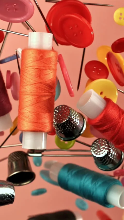 Various sewing supplies fly on a colored background. Filmed on a high-speed Stock Footage 335384640