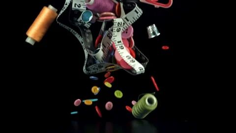 Various sewing tools fall on the table. Filmed on a high-speed camera at 1000 Stock Footage 322745917