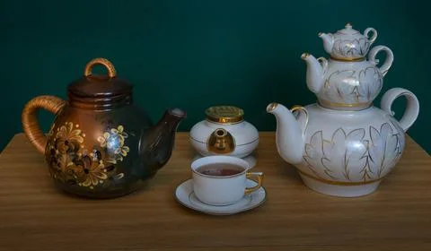 Various shape and purpose teapots on the table Stock Photos