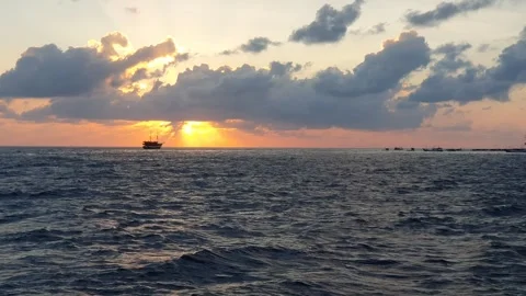 Various shapes of clouds in the sky as the sun rises over the sea 스톡 동영상 336625785