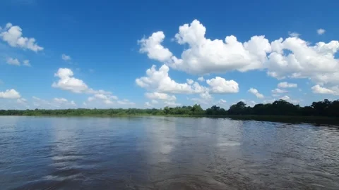 Various shapes of white clouds in the blue sky and river water Stockbeeldmateriaal 337525075