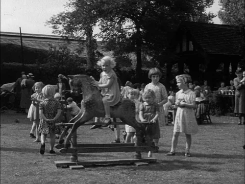 Various shots of children playing in kindergarten on a sunny day, UK 1940 Stock Footage 133388024
