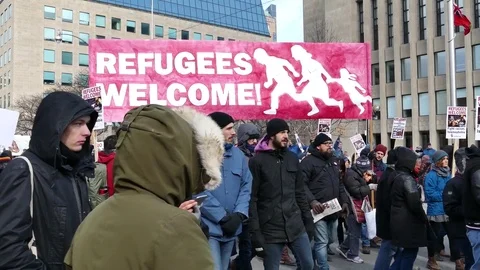 Various shots of demonstrators walking and holding signs at Toronto protest Stock Footage 76916567