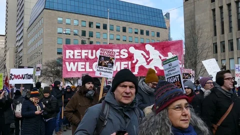Various shots of demonstrators walking and holding signs at Toronto protest - Stock Footage 91918155