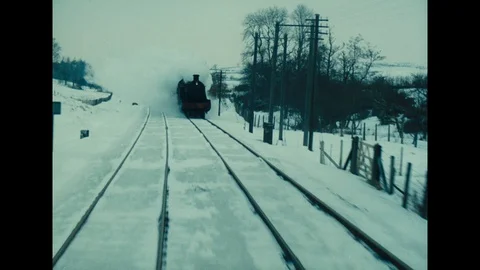 Various shots from a train moving through heavily snowy countryside, UK 1963 Stock Footage 133281638
