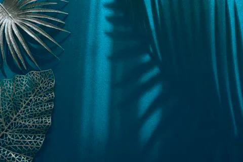 Various silver painted palm leaves over blue background with different shadow Stock Photos