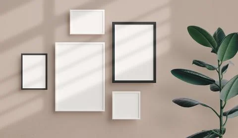 Various sizes of minimal photo frames mockup hanging on the apartment wall. M Stock Photos