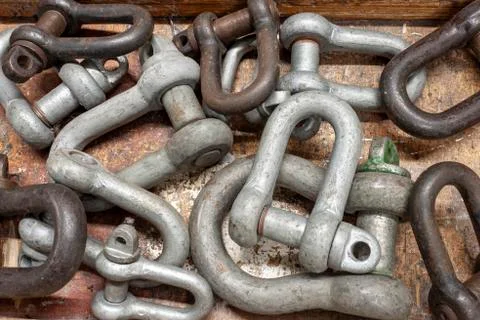 Various sizes of shackles on a workbench Stock Photos