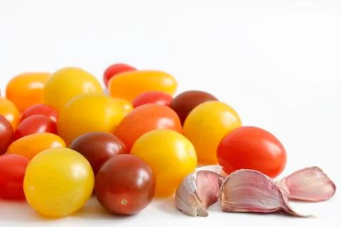 Various small tomatoes with garlic Stock Photos