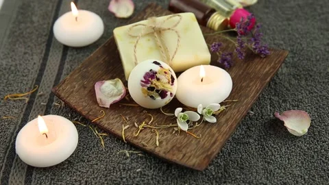 Various spa bath products on brown wooden tray creamy bath bomb. Video stock 147329935