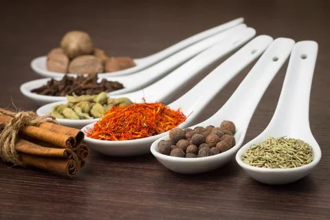 Various of Spice in Ceramic Spoon on Wood background Stockfoto's