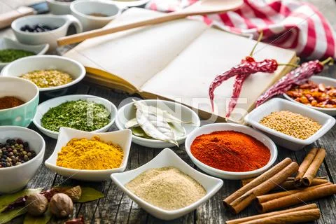 Various spices and blank cookbook. Stock Photos