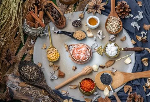 Various spices and herbs in rustic style with honey on balck background. Foto stock
