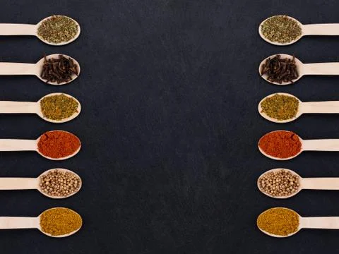 Various spices on dark background. Top view with copy space Stock Photos