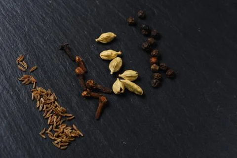 Various of spices. Flat lay of spices on the black stone Stock Photos