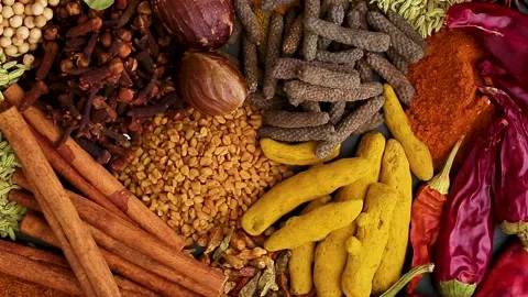 Various spices, peppers and herbs close-up top view in a circular rotation. Stock Footage 153084853