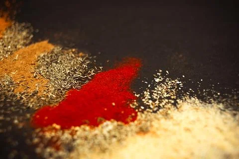 Various spices scattered on a black background Stock Photos