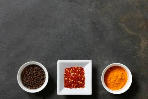 Various spices on slate background Stock Photos